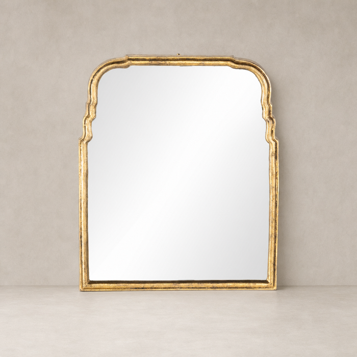 Antiqued Gold Leaf Rhone Mirror with intricate arched detailing and a reflective surface.
