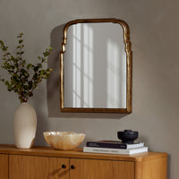 Antiqued Gold Leaf Rhone Mirror with an elegant arched design in a stylish decor setting.