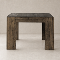 Brisa Dining Table in ebony rustic wormwood oak with sturdy, square legs and a textured finish.