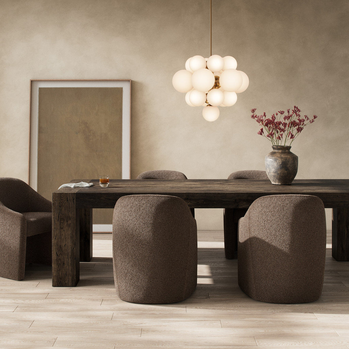 Brisa Dining Table in ebony rustic wormwood oak with a natural finish, styled in a cozy dining room.
