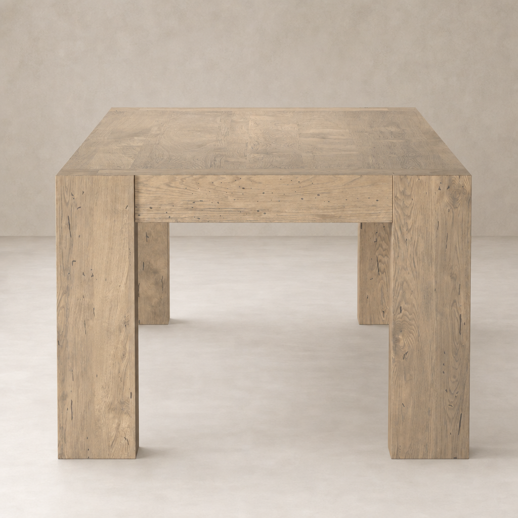 Brisa Dining Table in whitewash rustic wormwood oak with sturdy, square legs and textured surface.