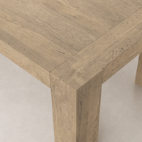 Brisa Dining Table in whitewash rustic wormwood oak with visible wood grain texture.