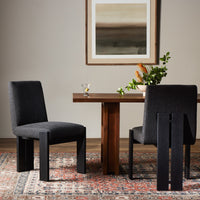 Romy Dining Chair in Gibson Black with minimalist design, set against a modern dining room.