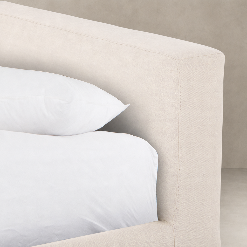 Slipcover bed in Brussels Natural fabric with soft white bedding.