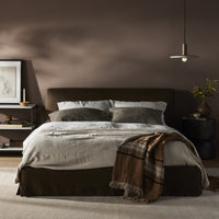 Slipcover bed in Brussels Coffee with layered bedding and decorative pillows.