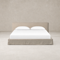 Slipcover bed in Savoy Parchment featuring a soft, upholstered headboard and clean lines.