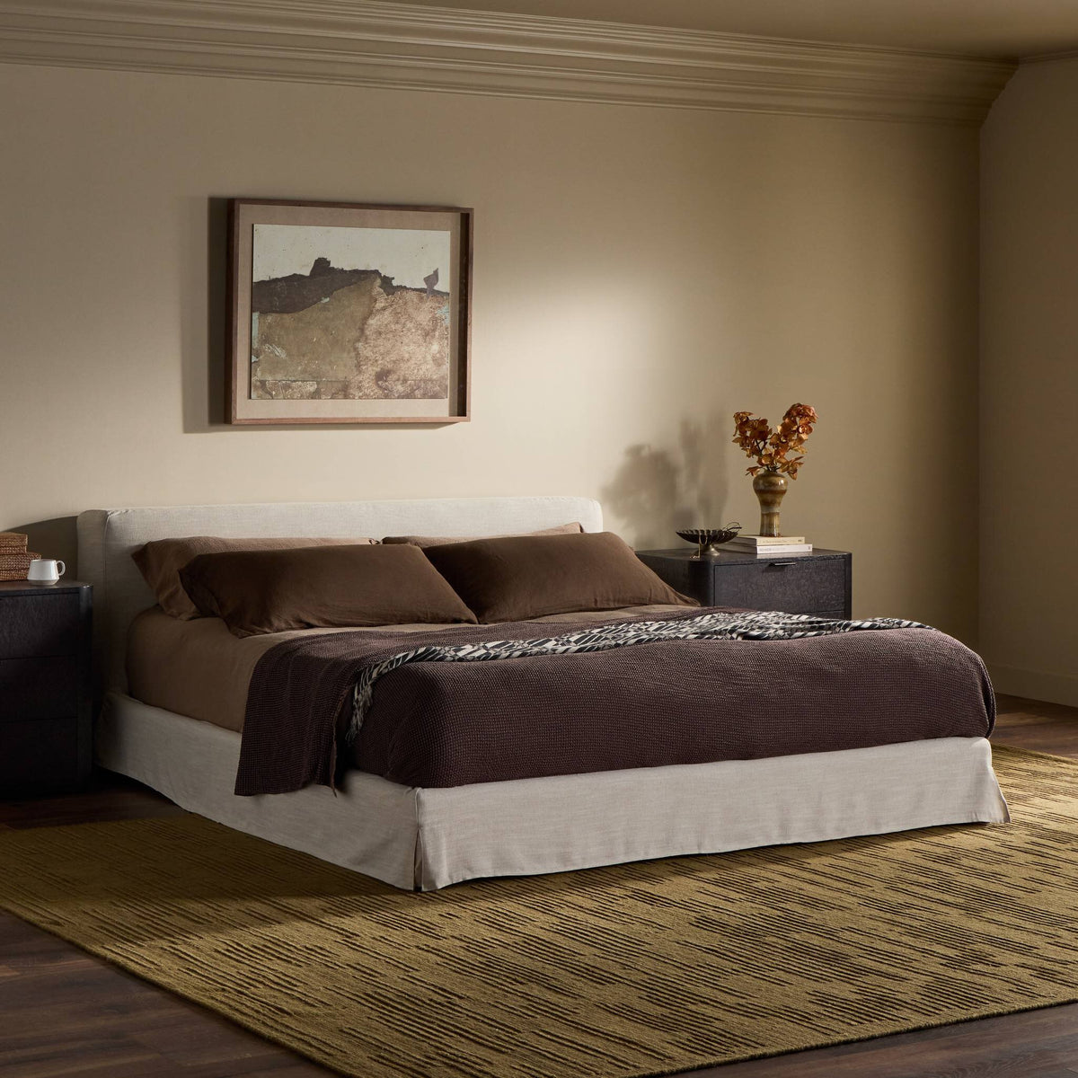 Slipcover bed in Savoy Parchment with brown bedding and stylish decor.