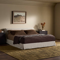 Slipcover bed in Savoy Parchment with brown bedding and stylish decor.