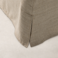 Close-up of a Savoy Parchment slipcover bed with textured fabric and tailored seams.