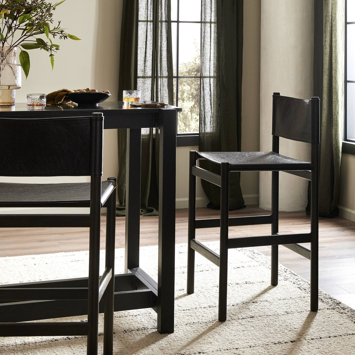 Bremen Bar + Counter Stool in Sonoma Black with Charcoal Parawood, stylishly integrated in a modern dining area.