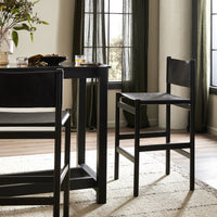 Bremen Bar + Counter Stool in Sonoma Black with Charcoal Parawood, stylishly integrated in a modern dining area.