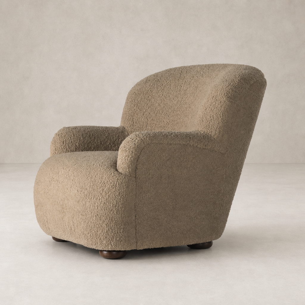 Ojai Chair in Sheepskin Camel with a plush, rounded design and sturdy wooden legs.