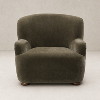 Stylish Ojai Chair in Malmo Olive with soft curves and cozy fabric texture.