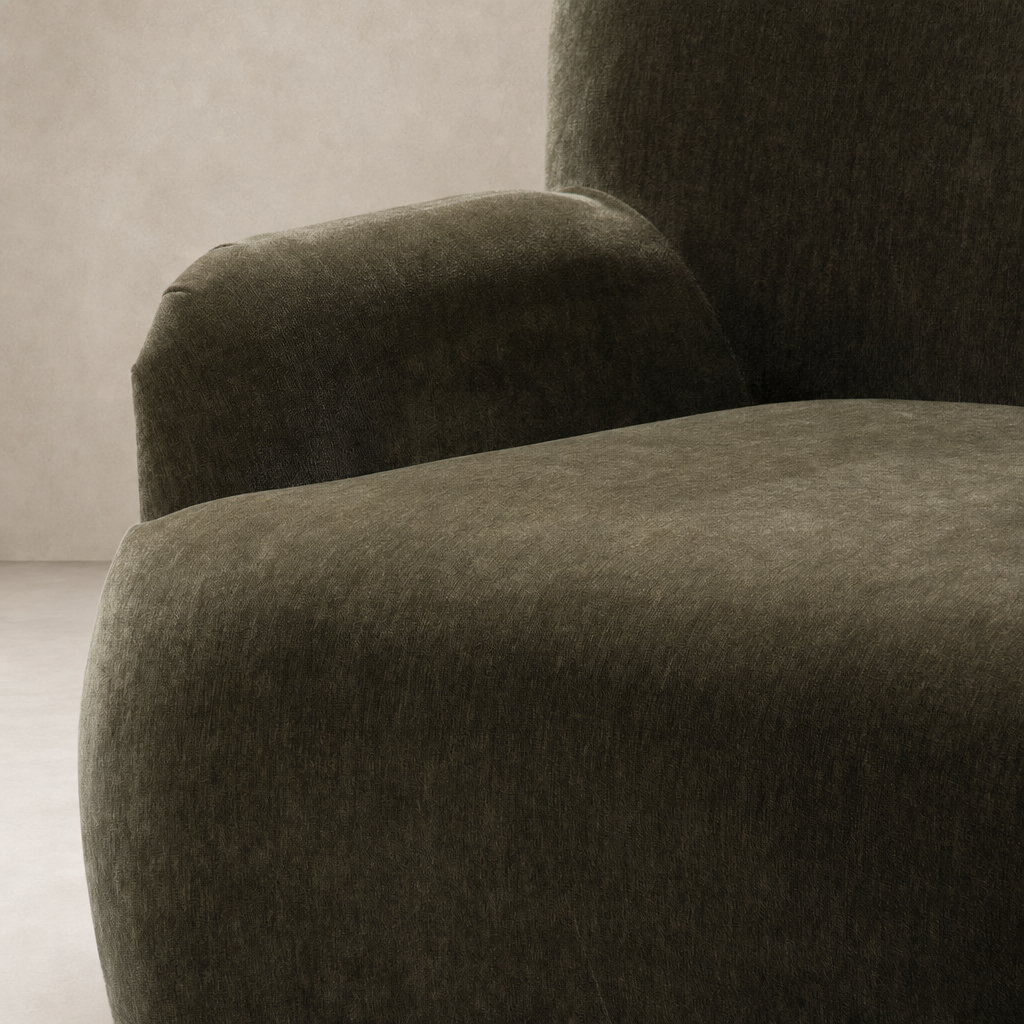 Close-up of Ojai Chair in Malmo Olive, showcasing its soft, textured upholstery and rounded armrests.