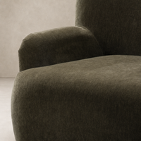 Close-up of Ojai Chair in Malmo Olive, showcasing its soft, textured upholstery and rounded armrests.