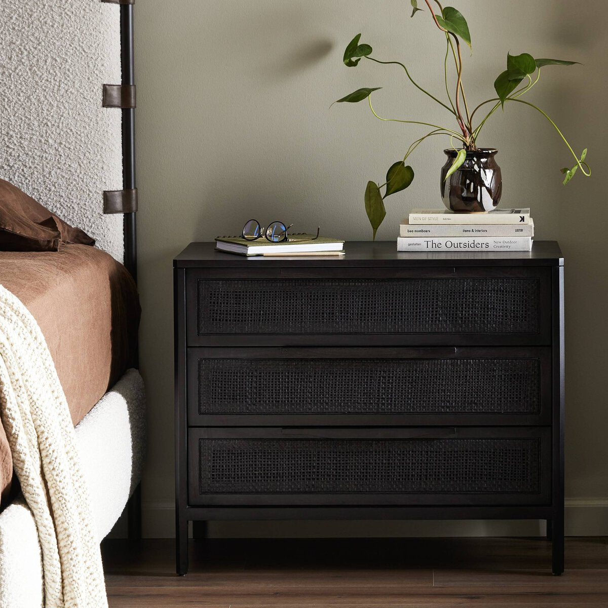 Black washed wood and rattan nightstand  in stylish bedroom