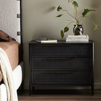 Black washed wood and rattan nightstand  in stylish bedroom
