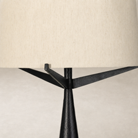Hammered black aluminum floor lamp with a textured base and cream fabric shade.