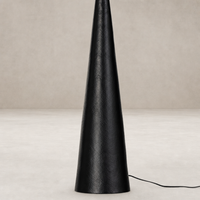 Hammered black aluminum floor lamp with a sleek, conical design.