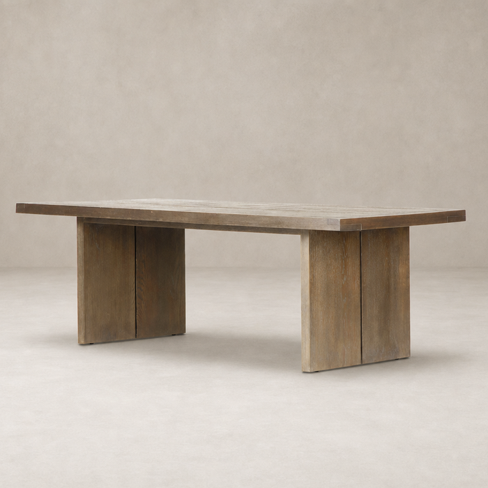 Sevilla Dining Table in worn oak with a sleek, modern design and sturdy supports.