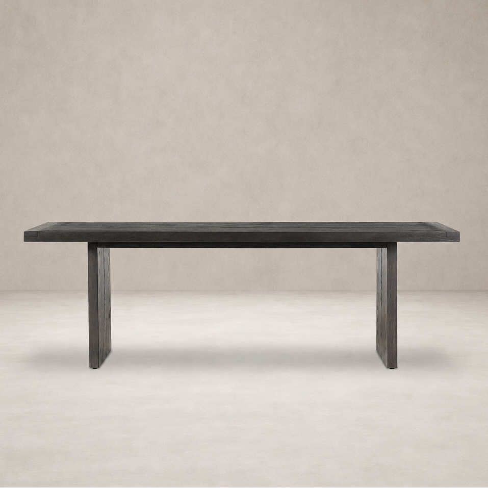 Sevilla Dining Table in worn black oak with a minimalist design and sturdy legs.