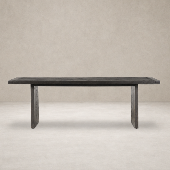 Sevilla Dining Table in worn black oak with a minimalist design and sturdy legs.