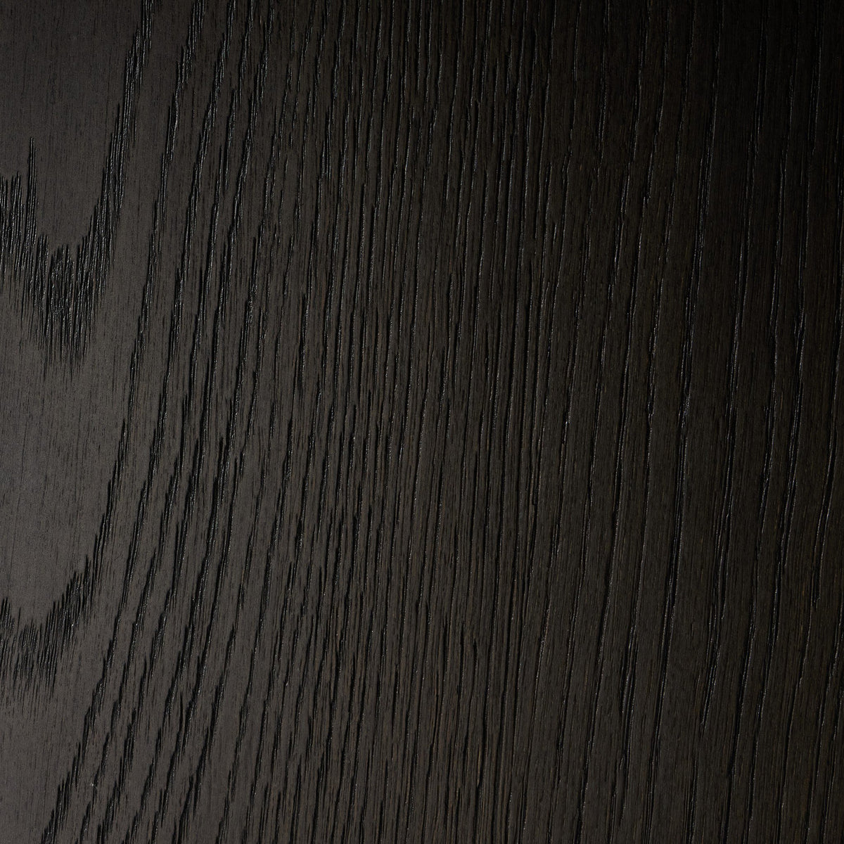 Close-up of the textured surface of Sevilla Dining Table in worn black oak.