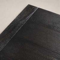 Worn Black Oak Sevilla Dining Table showcasing a textured wooden finish and sleek design.
