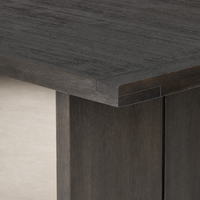 Sevilla Dining Table featuring a sleek, worn black oak finish and sturdy construction.
