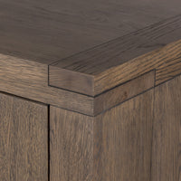 Whitby Sideboard in worn oak featuring a smooth, angular top and textured finish.