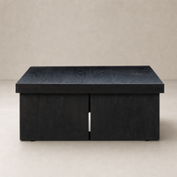 Stylish Darby Coffee Table in worn black with a sleek, modern design and textured surface.
