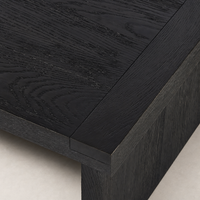 Darby Coffee Table in worn black featuring a textured wood finish and clean lines.