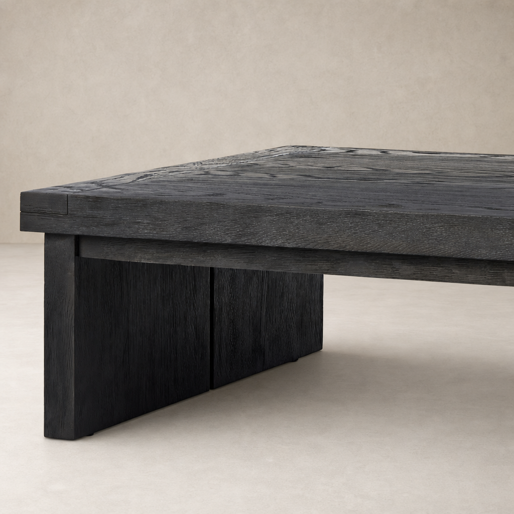 Worn black Darby coffee table with a textured surface and sturdy block legs.