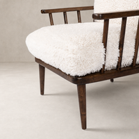 Whitley Chair in Andes Natural with plush, textured upholstery and dark wooden frame.