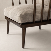 Whitley Chair in Manchester Flint features a plush striped cushion and sleek wooden legs.
