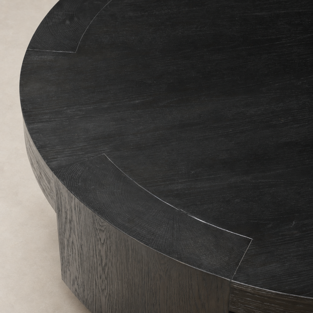 Hastings Coffee Table in Charcoal Oak featuring a sleek round design and textured finish.