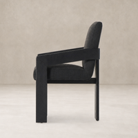 Side view of a Gibson Black dining armchair with modern design and plush upholstery.