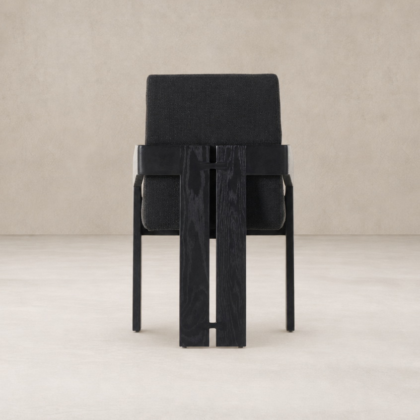 Black dining armchair with a cushioned seat and stylish wood frame.