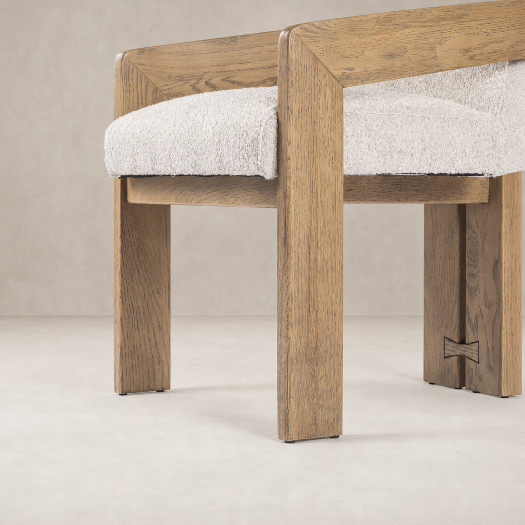 Dining armchair with Somerton Ash wood frame and textured cream upholstery.