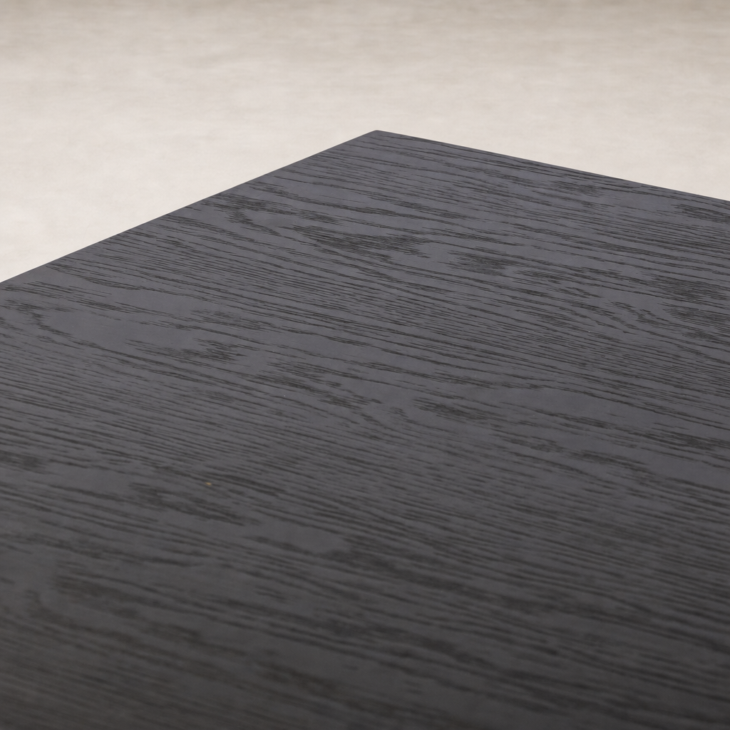 Charcoal oak Uma Desk with a smooth, textured surface showcasing wood grain.
