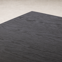 Charcoal oak Uma Desk with a smooth, textured surface showcasing wood grain.