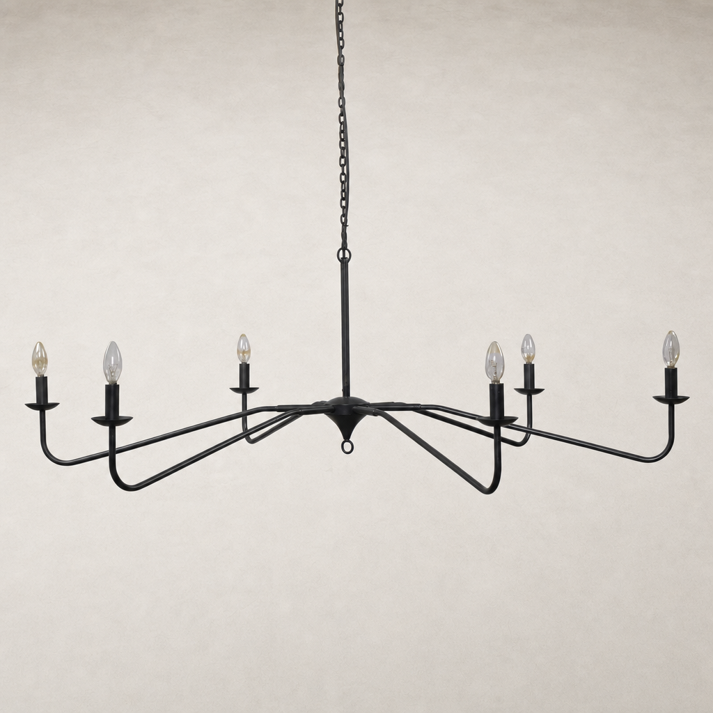 Antiqued iron chandelier with elegant curved arms and candle-style bulbs.