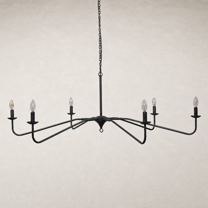 Antiqued iron chandelier with elegant curved arms and candle-style bulbs.