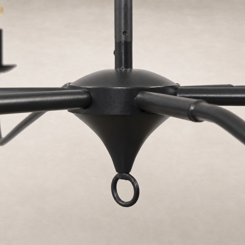 Antiqued iron chandelier featuring a sleek, minimalist design with elegant curved arms.