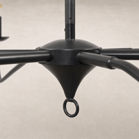Antiqued iron chandelier featuring a sleek, minimalist design with elegant curved arms.