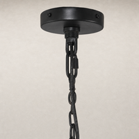 Antiqued iron chandelier with decorative chain and circular ceiling plate.