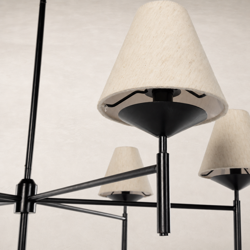 Jet black chandelier with cream lampshades and modern geometric design.