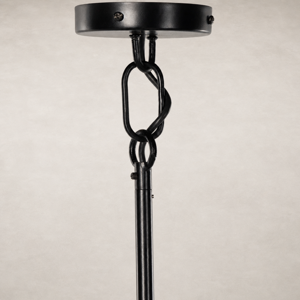 Jet black chandelier with intricate chain link detailing and smooth finish.