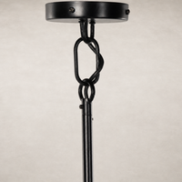 Jet black chandelier with intricate chain link detailing and smooth finish.