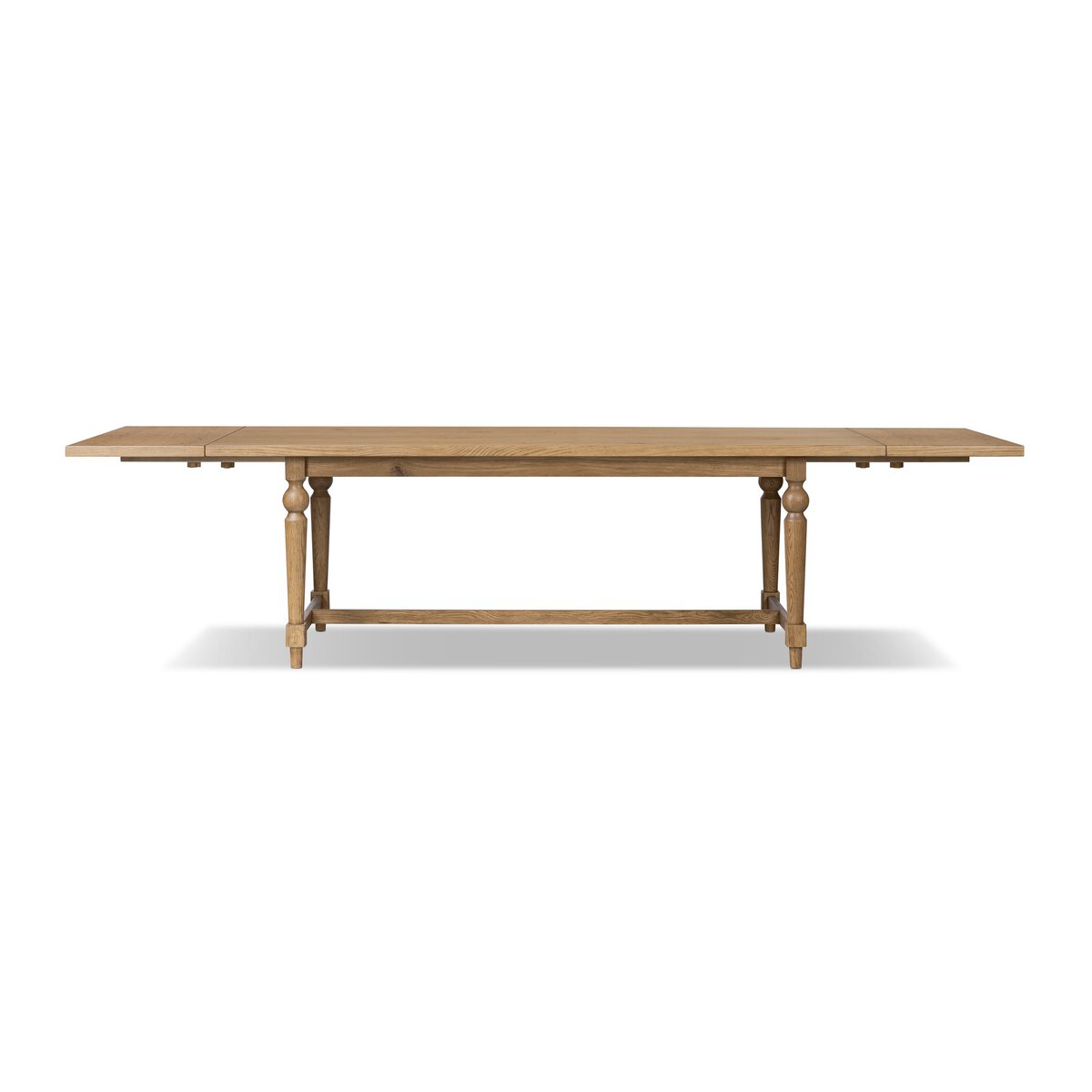 Side view of the Menorca Extension Dining Table in natural wood, showcasing its elegant design and extendable feature.